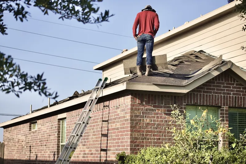 Professional roofer working on a residential roof in Monponsett